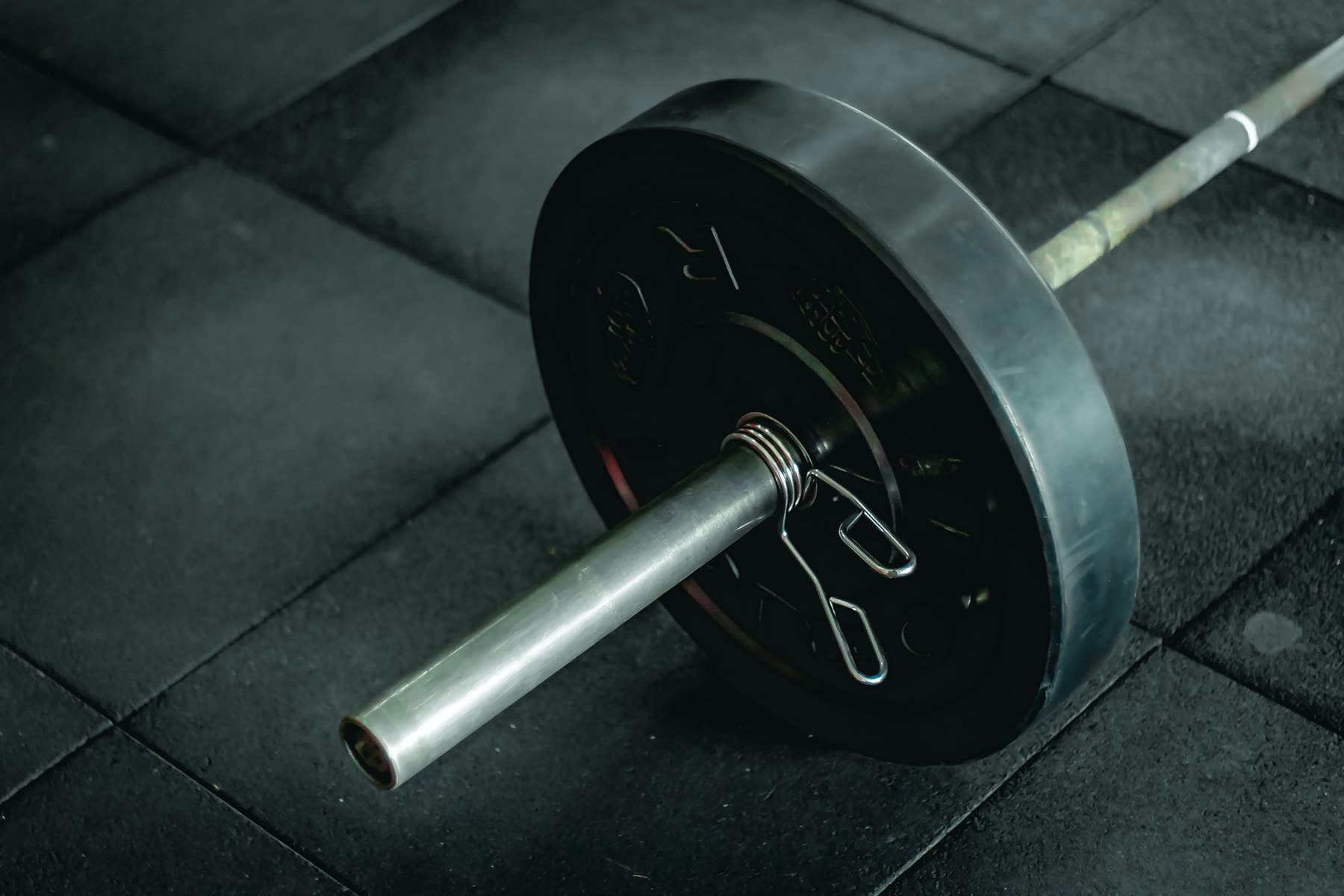 Loaded barbell on a weight room floor