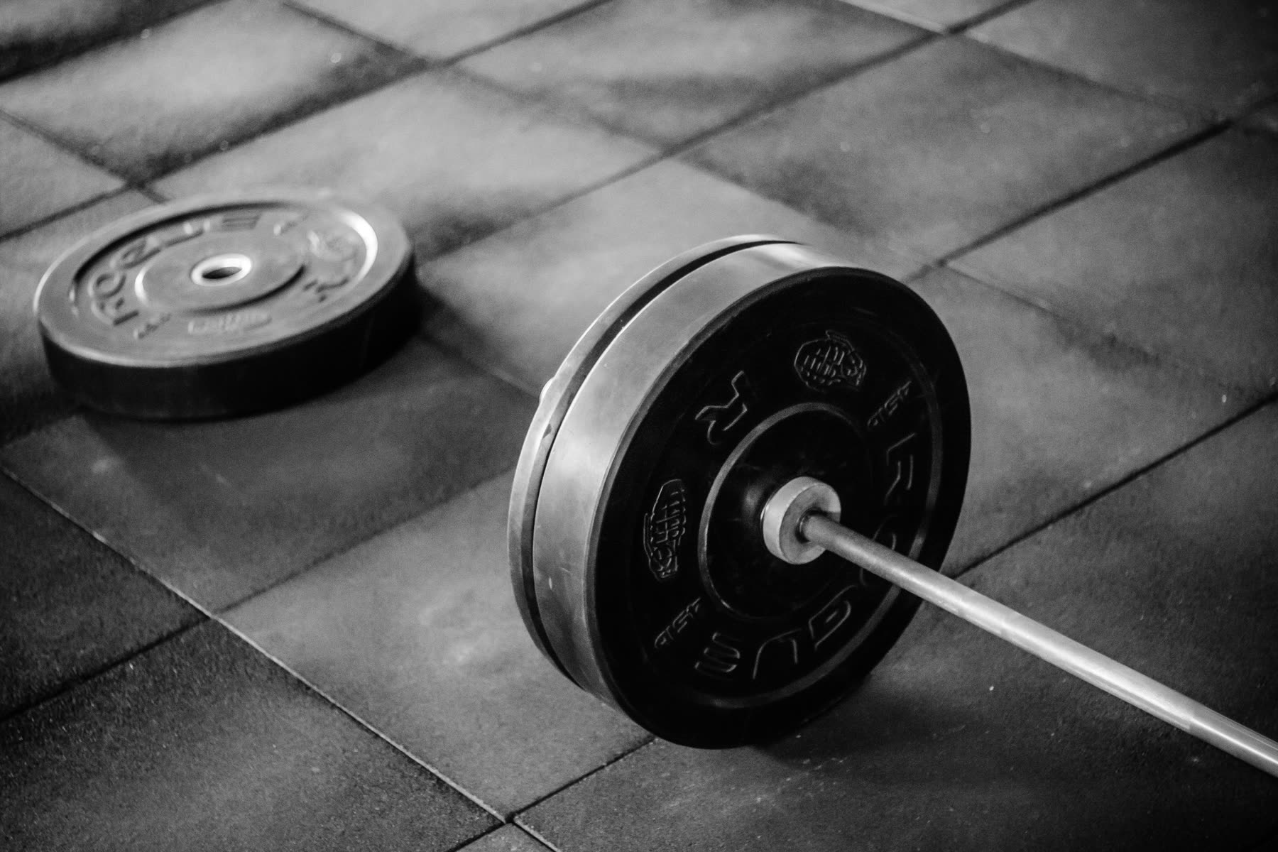 Barbell and plate on a gym floor
